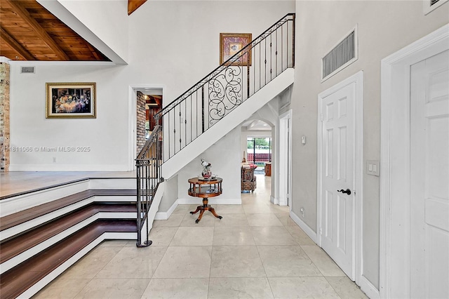 863 W Coco Plum Cir, Plantation, FL 33324 - stairs featuring a high ceiling, tile patterned flooring, and baseboards
