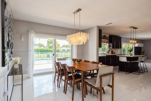 7625 SW 108th Ter, Pinecrest, FL 33156 - dining space with a chandelier, baseboards, and light tile patterned floors