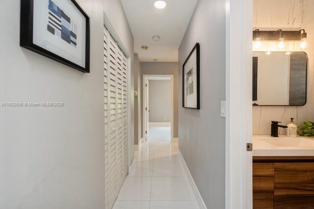 7625 SW 108th Ter, Pinecrest, FL 33156 - hallway with tile patterned flooring, a sink, and baseboards