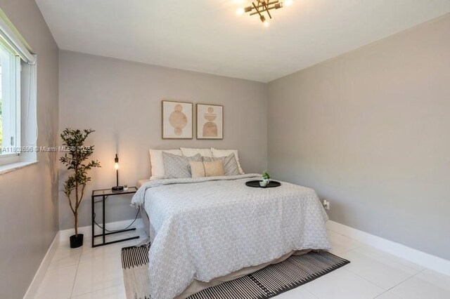 7625 SW 108th Ter, Pinecrest, FL 33156 - bedroom featuring light tile patterned floors and baseboards