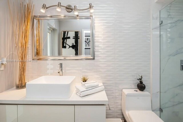 7625 SW 108th Ter, Pinecrest, FL 33156 - bathroom featuring tile walls, vanity, a shower stall, and toilet