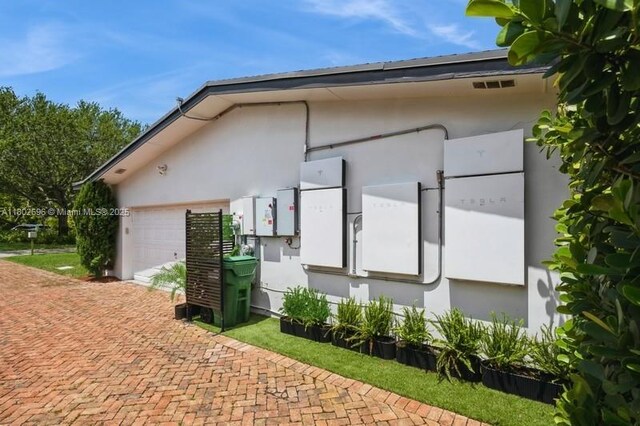 7625 SW 108th Ter, Pinecrest, FL 33156 - view of home's exterior with stucco siding, decorative driveway, and an attached garage
