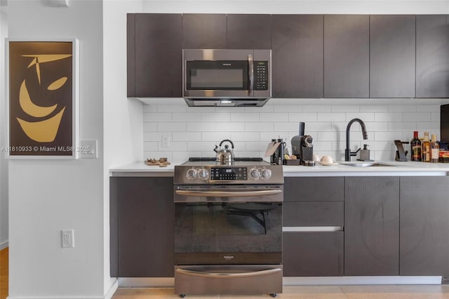 398 NE 5th St Unit 3803, Miami, FL 33132 - kitchen featuring appliances with stainless steel finishes, a sink, tasteful backsplash, and modern cabinets
