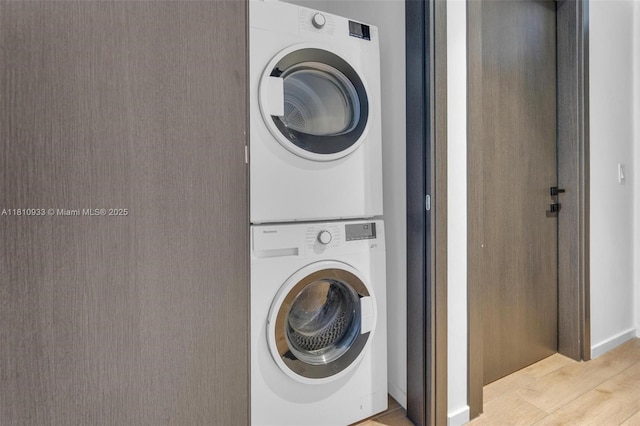 398 NE 5th St Unit 3803, Miami, FL 33132 - washroom with stacked washer and clothes dryer and wood finished floors