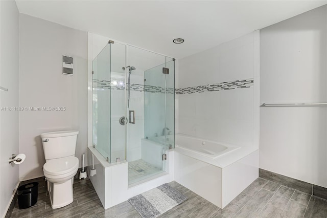 6967 SW 115th Pl Unit B34, Miami, FL 33173 - bathroom with wood finish floors, a bath, toilet, and a shower stall