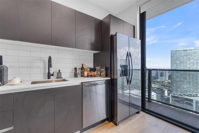 398 NE 5th St Unit 3503, Miami, FL 33132 - kitchen featuring appliances with stainless steel finishes, a sink, modern cabinets, backsplash, and light countertops