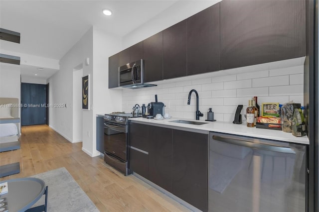 398 NE 5th St Unit 3503, Miami, FL 33132 - kitchen featuring appliances with stainless steel finishes, a sink, light countertops, backsplash, and modern cabinets