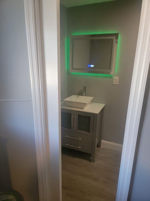 2211 Rutland St, Opa Locka, FL 33054 - bathroom with vanity, wood finished floors, and baseboards