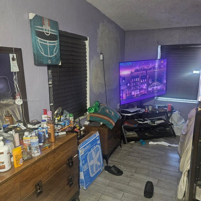2211 Rutland St, Opa Locka, FL 33054 - living area featuring wood finished floors, a textured ceiling, and a textured wall