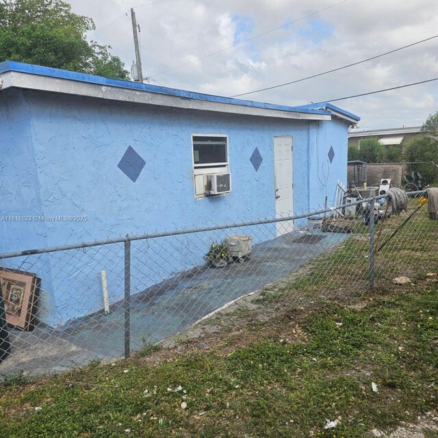 2211 Rutland St, Opa Locka, FL 33054 - view of home's exterior with stucco siding and cooling unit
