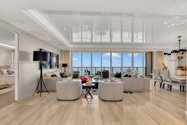 9701 Collins Ave Unit 2403S, Bal Harbour, FL 33154 - living area featuring a chandelier, light wood finished floors, and floor to ceiling windows