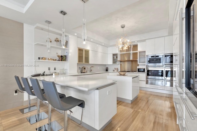 9701 Collins Ave Unit 2403S, Bal Harbour, FL 33154 - kitchen featuring open shelves, light wood-style flooring, a warming drawer, a peninsula, and recessed lighting