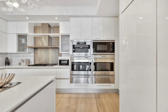 9701 Collins Ave Unit 2403S, Bal Harbour, FL 33154 - kitchen with a warming drawer, stainless steel double oven, and white cabinets
