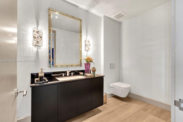 9701 Collins Ave Unit 2403S, Bal Harbour, FL 33154 - bathroom featuring wood finished floors, toilet, and vanity