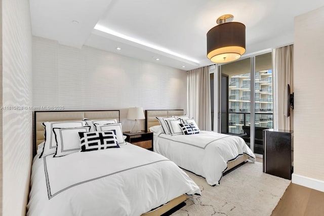 9701 Collins Ave Unit 2403S, Bal Harbour, FL 33154 - bedroom with wood finished floors, wallpapered walls, expansive windows, baseboards, and recessed lighting