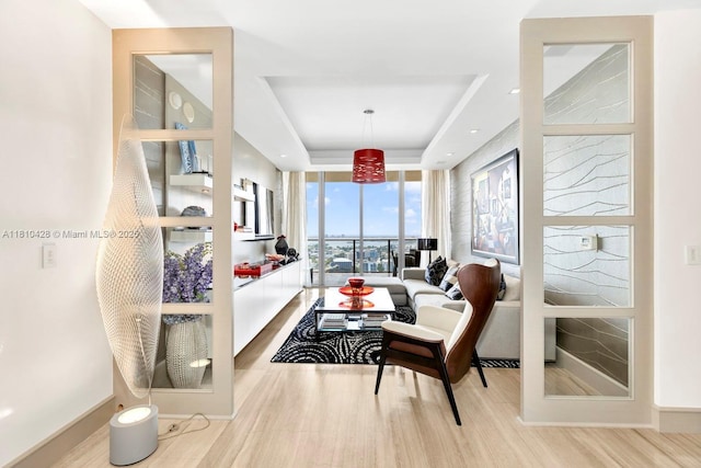 9701 Collins Ave Unit 2403S, Bal Harbour, FL 33154 - living area with wood finished floors, a tray ceiling, and baseboards
