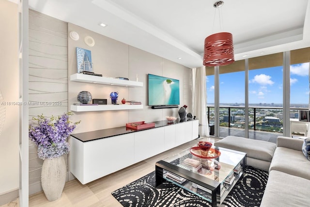 9701 Collins Ave Unit 2403S, Bal Harbour, FL 33154 - living area featuring floor to ceiling windows, light wood finished floors, a tray ceiling, and recessed lighting