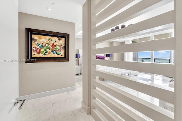 9701 Collins Ave Unit 2403S, Bal Harbour, FL 33154 - corridor with marble look tile flooring and baseboards