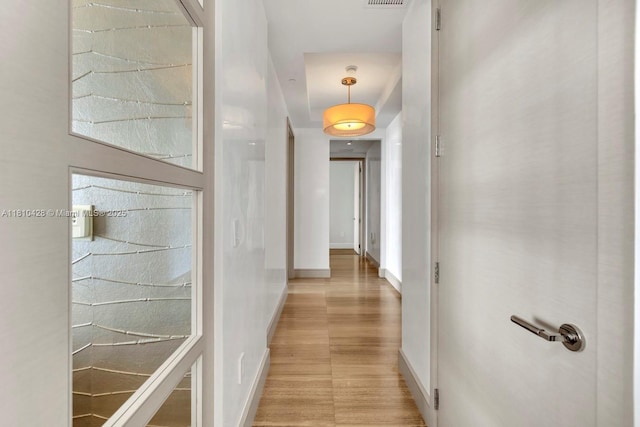 9701 Collins Ave Unit 2403S, Bal Harbour, FL 33154 - hallway featuring baseboards and light wood finished floors
