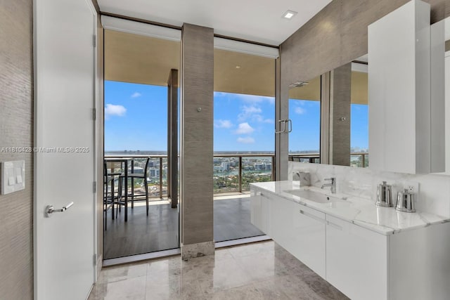 9701 Collins Ave Unit 2403S, Bal Harbour, FL 33154 - bathroom featuring vanity, expansive windows, and tile patterned floors
