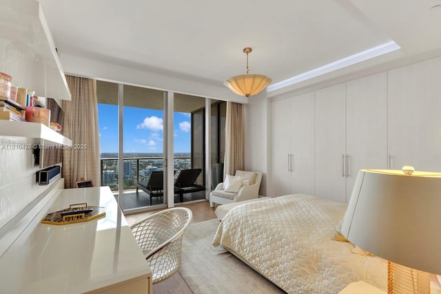 9701 Collins Ave Unit 2403S, Bal Harbour, FL 33154 - bedroom featuring wood finished floors, expansive windows, and access to exterior