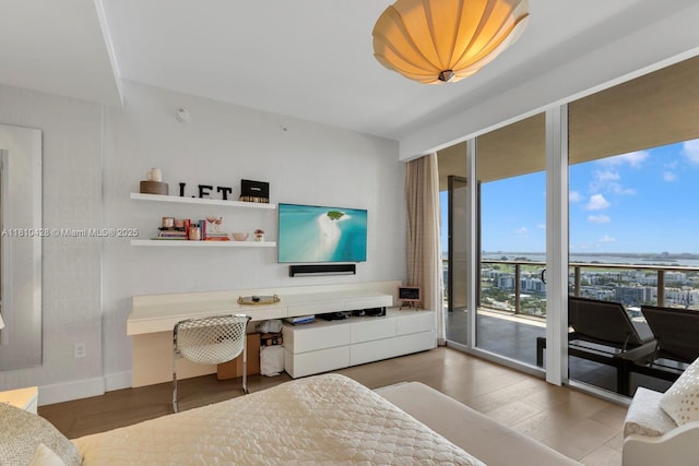 9701 Collins Ave Unit 2403S, Bal Harbour, FL 33154 - bedroom with a wall of windows, wood finished floors, access to exterior, and a desk