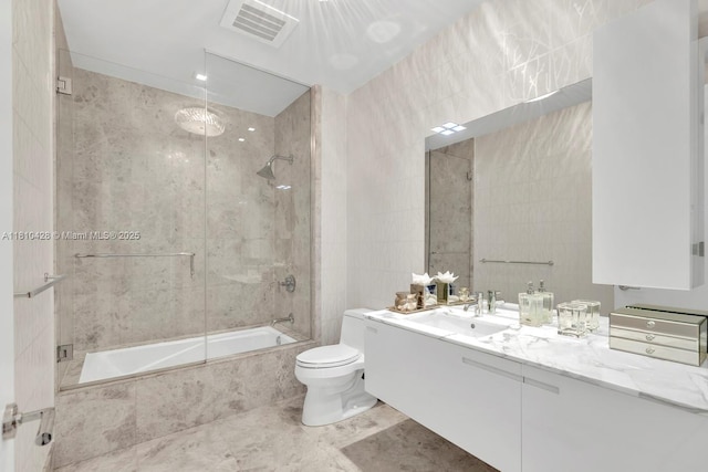 9701 Collins Ave Unit 2403S, Bal Harbour, FL 33154 - full bathroom with tile walls, vanity, tiled shower / bath combo, toilet, and tile patterned floors