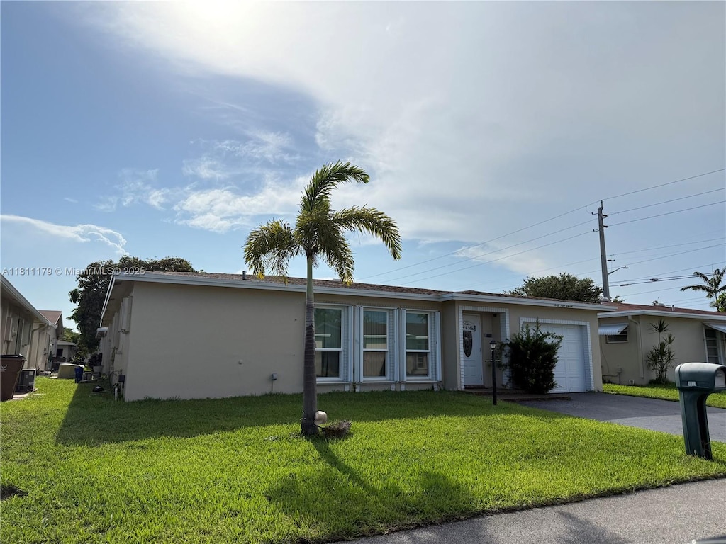 4911 NW 14th Ave, Deerfield Beach, FL 33064 - ranch-style house featuring a garage, asphalt driveway, stucco siding, and a front lawn