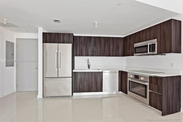 488 NE 18th St Unit 501, Miami, FL 33132 - kitchen featuring stainless steel appliances, modern cabinets, dark brown cabinetry, and light countertops