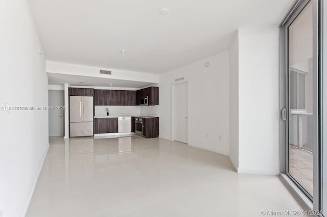 488 NE 18th St Unit 501, Miami, FL 33132 - unfurnished living room featuring light tile patterned floors, a sink, and baseboards