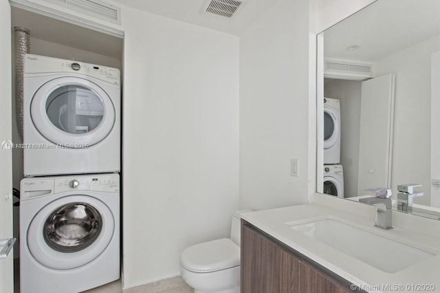 488 NE 18th St Unit 501, Miami, FL 33132 - bathroom featuring stacked washer / dryer, vanity, and toilet