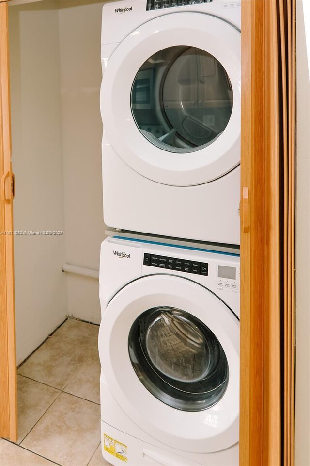 7191 W 24th Ave Unit 31-Ph7, Hialeah, FL 33016 - washroom featuring stacked washing machine and dryer and light tile patterned flooring