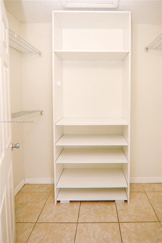 7191 W 24th Ave Unit 31-Ph7, Hialeah, FL 33016 - spacious closet with light tile patterned floors