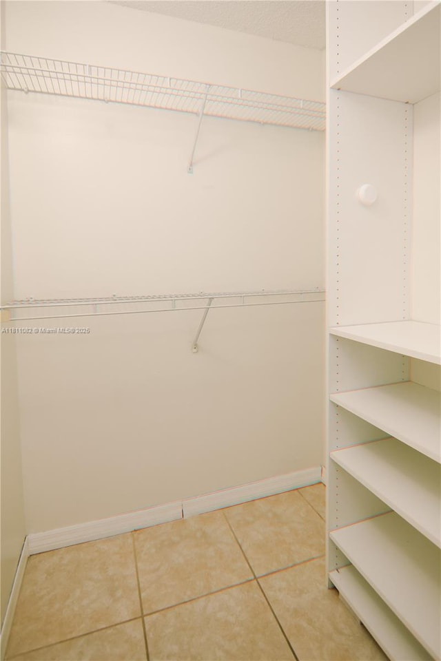 7191 W 24th Ave Unit 31-Ph7, Hialeah, FL 33016 - spacious closet featuring light tile patterned floors