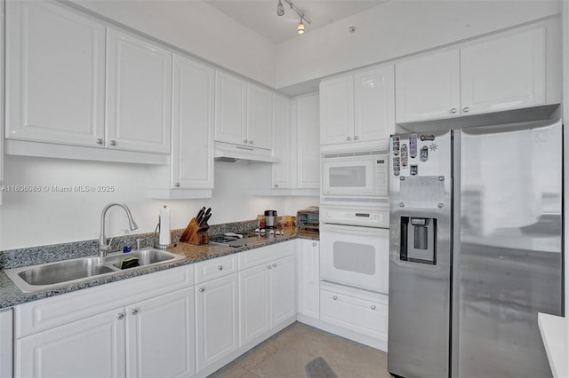 4779 Collins Ave Unit 4006, Miami Beach, FL 33140 - kitchen featuring white appliances, a sink, under cabinet range hood, and white cabinets