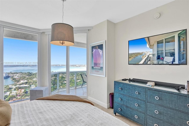 4779 Collins Ave Unit 4006, Miami Beach, FL 33140 - bedroom featuring a water view, baseboards, and light colored carpet