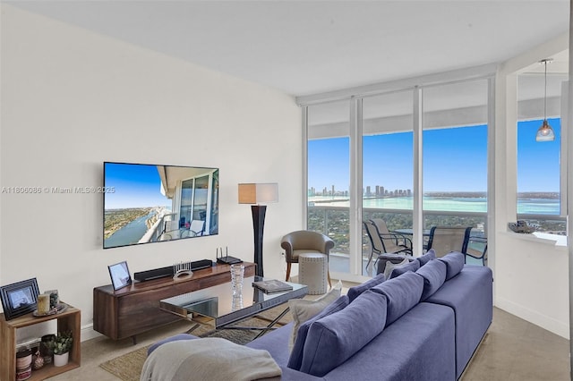 4779 Collins Ave Unit 4006, Miami Beach, FL 33140 - living room featuring healthy amount of natural light, expansive windows, and baseboards