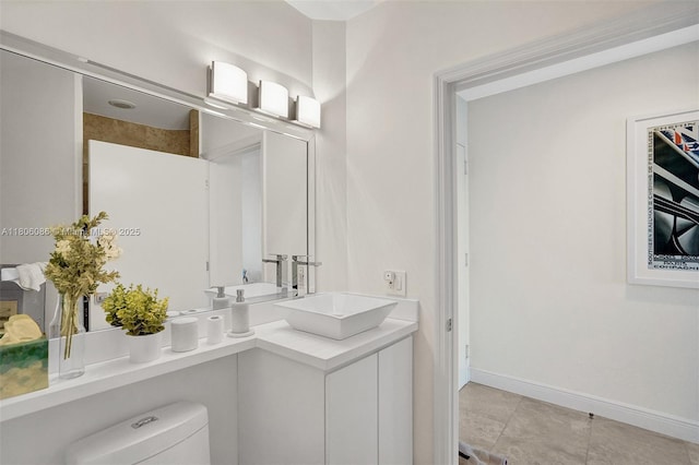 4779 Collins Ave Unit 4006, Miami Beach, FL 33140 - bathroom with toilet, vanity, baseboards, and tile patterned floors
