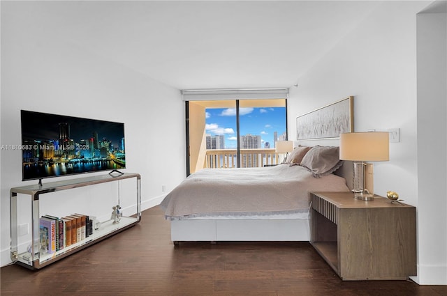 1000 Island Blvd Unit 2508, Aventura, FL 33160 - bedroom featuring access to outside, wood finished floors, a city view, a wall of windows, and baseboards