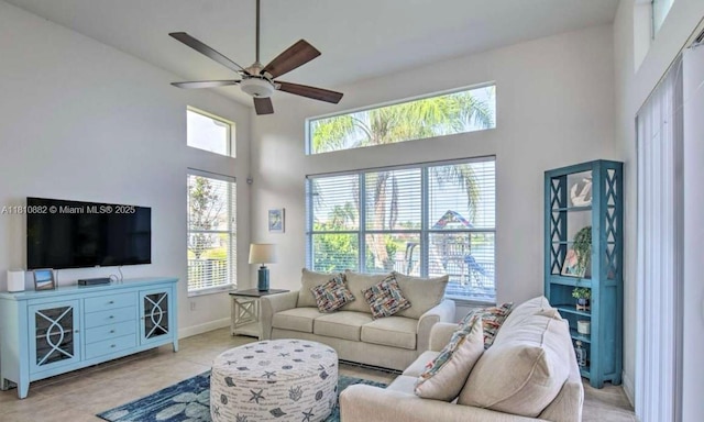 5342 SW 173rd Ave, Miramar, FL 33029 - living area with ceiling fan, a high ceiling, baseboards, and light tile patterned flooring