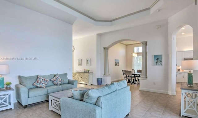 5342 SW 173rd Ave, Miramar, FL 33029 - living area featuring arched walkways, ornate columns, light tile patterned floors, and baseboards