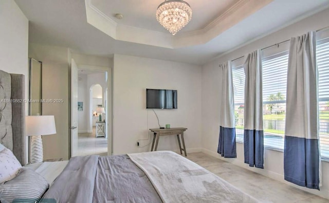 5342 SW 173rd Ave, Miramar, FL 33029 - tiled bedroom featuring a chandelier, a tray ceiling, arched walkways, baseboards, and crown molding