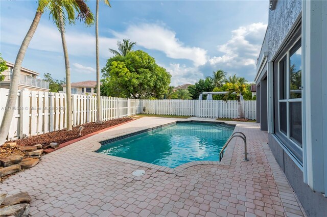 15862 SW 24th St, Miramar, FL 33027 - view of swimming pool featuring a patio area and a fenced backyard