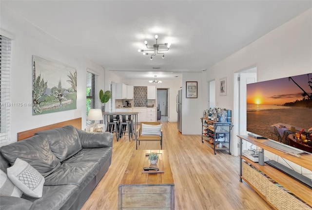 2763 NW 3rd St, Miami, FL 33125 - living area with a chandelier and light wood-style flooring