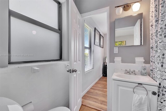 2763 NW 3rd St, Miami, FL 33125 - bathroom featuring toilet, wood finished floors, vanity, and baseboards