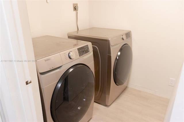 2200 S Cypress Bend Dr Unit 204, Pompano Beach, FL 33069 - laundry area featuring separate washer and dryer and baseboards
