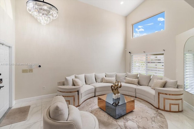 16466 SW 29th St, Miramar, FL 33027 - living room featuring marble finish floors, a high ceiling, a chandelier, and baseboards