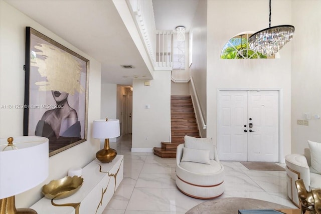 16466 SW 29th St, Miramar, FL 33027 - foyer entrance with light marble finish flooring, stairway, baseboards, and a chandelier