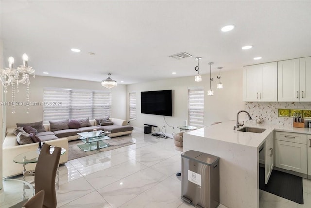 16466 SW 29th St, Miramar, FL 33027 - kitchen with a sink, open floor plan, tasteful backsplash, a chandelier, and recessed lighting