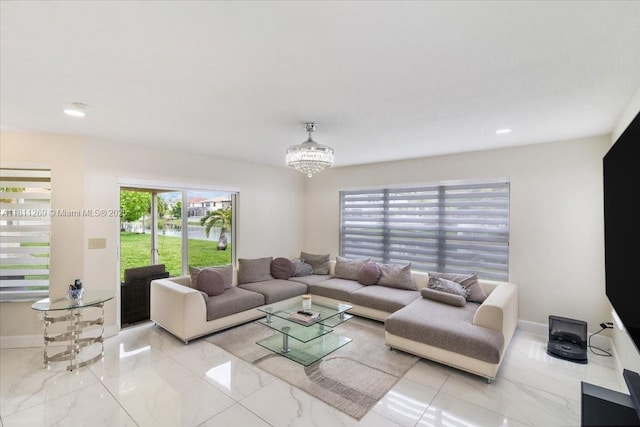 16466 SW 29th St, Miramar, FL 33027 - living area with marble tiled floors, healthy amount of natural light, a chandelier, baseboards, and recessed lighting